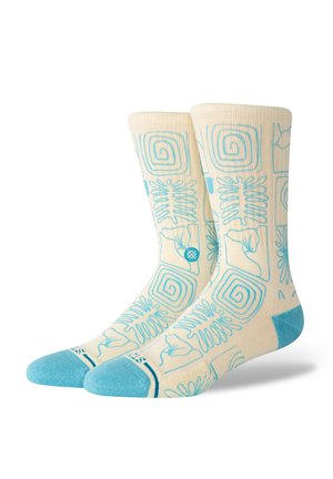 Light cream socks featuring blue patterns of spirals, floral designs, and abstract shapes. Accented with a solid blue toe and cuff.