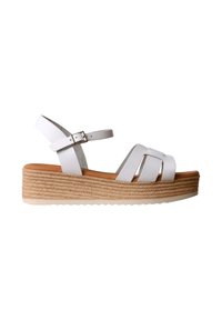 Sandale plateforme en cuir blanc avec semelle en jute tressée, bride cheville et fermeture à boucle, vue de côté sur fond blanc.