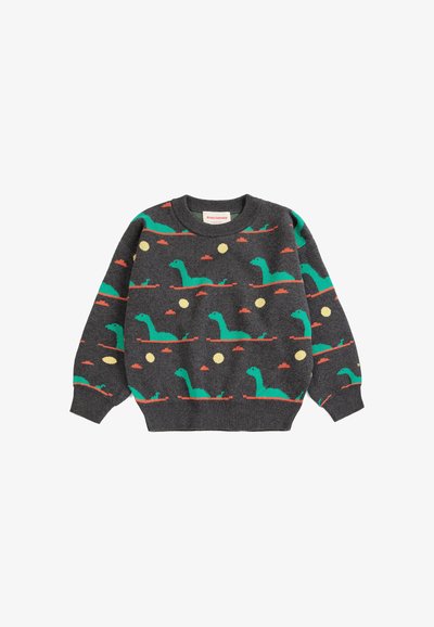 Pull gris foncé avec motif répétitif de dinosaure vert et soleil en orange et jaune, manches longues et poignets et ourlet en côtes.