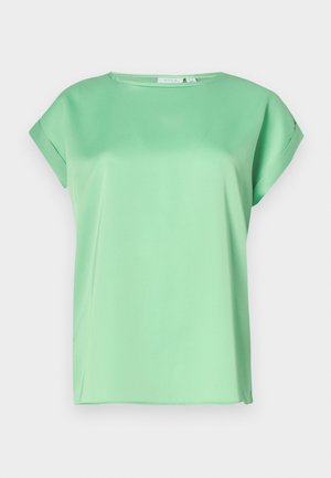 Mere roheline lühikeste varrukatega pluus ümmarguse kaelusega ja sileda, kergest kangast. Omab vabaltlangevat lõiget ja õrnu külgjalgu.