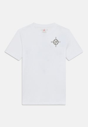 White short-sleeve T-shirt with a small black compass design on the left chest and a red Jordan logo on the collar tag.