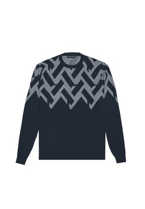 Pull à manches longues bleu marine avec un motif en zigzag blanc et un chevron rayé sur la poitrine et les épaules, col rond.