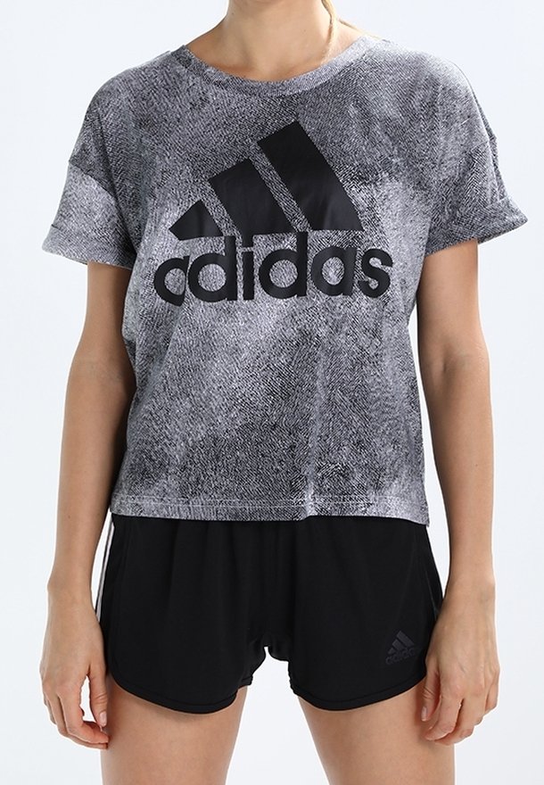 Black and gray patterned T-shirt with short sleeves, featuring a prominent black Adidas logo. Paired with black athletic shorts.