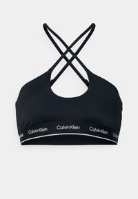 Reggiseno sportivo nero con scollatura a forma di U e spalline incrociate. Presenta un elastico con logo e lettering bianco. Texture liscia.