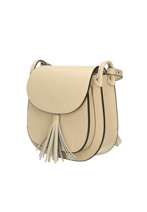 Beige leren crossbody tas met een ronde flap, kwastdetail en contrasterende zwarte rand. Voorzien van een verstelbare schouderband en een drukknoopsluiting.