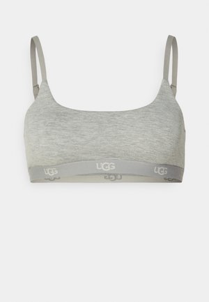 Graue Bralette mit verstellbaren Trägern und weichem Material. Verfügt über ein graues Band mit dem in hellgrau gedruckten UGG-Logo.