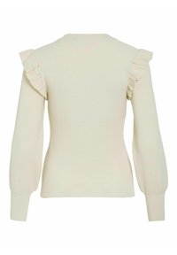 Pull en maille côtelée de couleur crème avec des manches longues bouffantes et des détails à volants sur les coutures des épaules, présenté de dos.