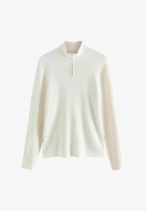 Krém színű pulóver magas nyakkal és negyed cipzárral. Textúrált rombusz mintázat jellemzi, hosszú ujjakkal.