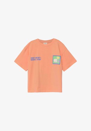 Krótka koszulka w kolorze brzoskwiniowym z niebieskim napisem "KIND HEART–BRAVE SPIRIT" i małą kwadratową grafiką owiec i słońca z przodu.