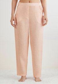 Ljusrosa, löst sittande byxor med en slät textur, elastisk midja och sidofickor, med en rak benstil.