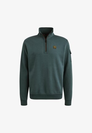 Pullover vert foncé en tissu doux avec un col zippé à mi-hauteur, des poignets côtelés et un petit logo brodé sur la poitrine.