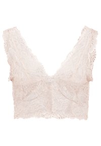 Bralette en dentelle de couleur crème, arborant un design en V, des bords festonnés et des motifs floraux sur toute sa surface. Texture douce et construction légère.