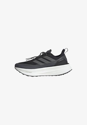 Black athletic shoe with a mesh upper, three grey stripes, a thick white sole, and textured detailing. Features a pull tab at the heel.