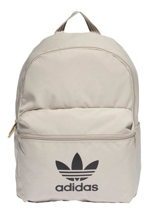 Beige Adidas-reppu, jossa etutasku vetoketjulla sekä musta trefoil-logo ja merkin nimi alareunassa etupaneelissa.