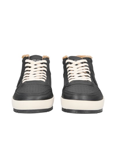 Black sneakers with a textured finish, white laces, and beige accents on the tongue. Rubber sole with patterned tread. Front view.
