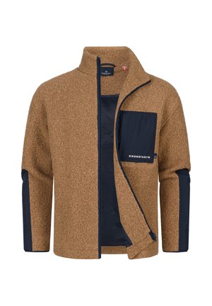 Braune Fleecejacke mit einer navy blauen Nylon-Tasche, Reißverschluss vorne, hohem Kragen und kontrastierenden navy blauen Ärmelakzenten. Markenlogo auf der Tasche.