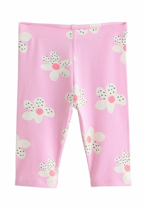 Różowe legginsy dla malucha z białymi stokrotkami, które mają różowe środki i płatki z czarnymi kropkami.