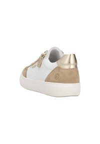 White sneaker with beige suede accents, metallic gold heel, and zip closure. Features a textured white sole and logo detail on the side.