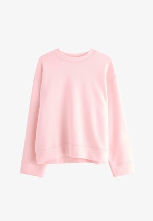 Vaaleanpunainen huppari, joka on valmistettu pehmeästä kankaasta. Hupparissa on pyöreä kaula-aukko, pudotetut olkapäät ja resorihaitarikumit, sekä rento istuvuus.