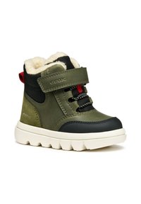 Stivale alla caviglia verde in pelle con accenti neri, suola in gomma bianca, cinturino regolabile e foderato in pile per il calore. Inclusi occhielli per i lacci.