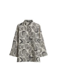 Chemise à motifs beige et noir, présentant des motifs de vagues et de lignes. Tissu léger avec un col et des manches trois-quarts.