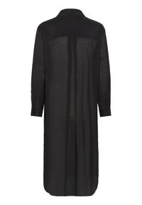 Rochie neagră, cu mânecă lungă, realizată dintr-un material ușor și transparent. Prezintă o guler și manșete cu nasturi, cu o croială dreaptă și pliuri la spate.