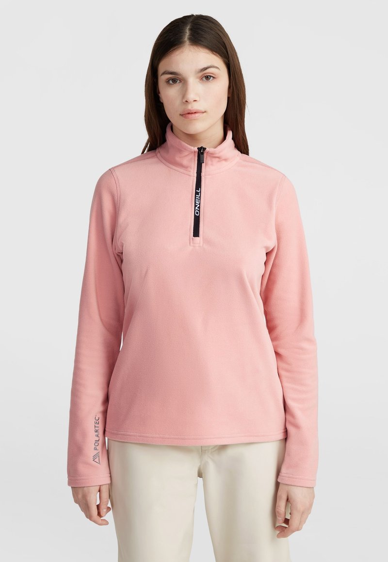 Light pink fleece pullover with a high collar and half-zip closure. Features Polartec branding on the sleeve and a soft texture.