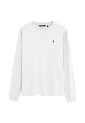 Maglia bianca a maniche lunghe con scollo tondo e piccolo logo scuro di giocatore di polo sul petto sinistro.
