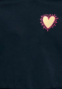 Navy sweatshirt with a gold heart graphic outlined in pink, featuring sunburst accents around the heart design. Soft cotton texture.