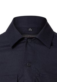 Granatowa koszula z guzikami, z klasycznym kołnierzykiem, jedną przednią kieszenią i kontrastującym przeszyciem. Tkanina ma gładką fakturę. Metka rozmiaru: 37-38.