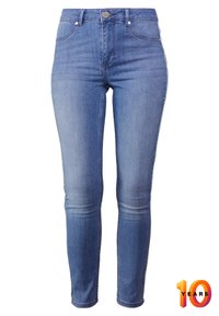 Jeans i ljusblå denim med slim fit, medelhög midja, fem fickor och subtila slitningar på låren.