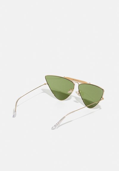 Gold metal sunglasses with triangular green lenses. Thin, clear-accented arms enhance the lightweight design. Sleek and modern aesthetic.