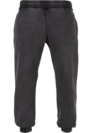 Pantaloni sport negri dintr-un material moale, cu talie și manșete elastice. Prezintă o textură netedă și o croială lejeră pentru confort.