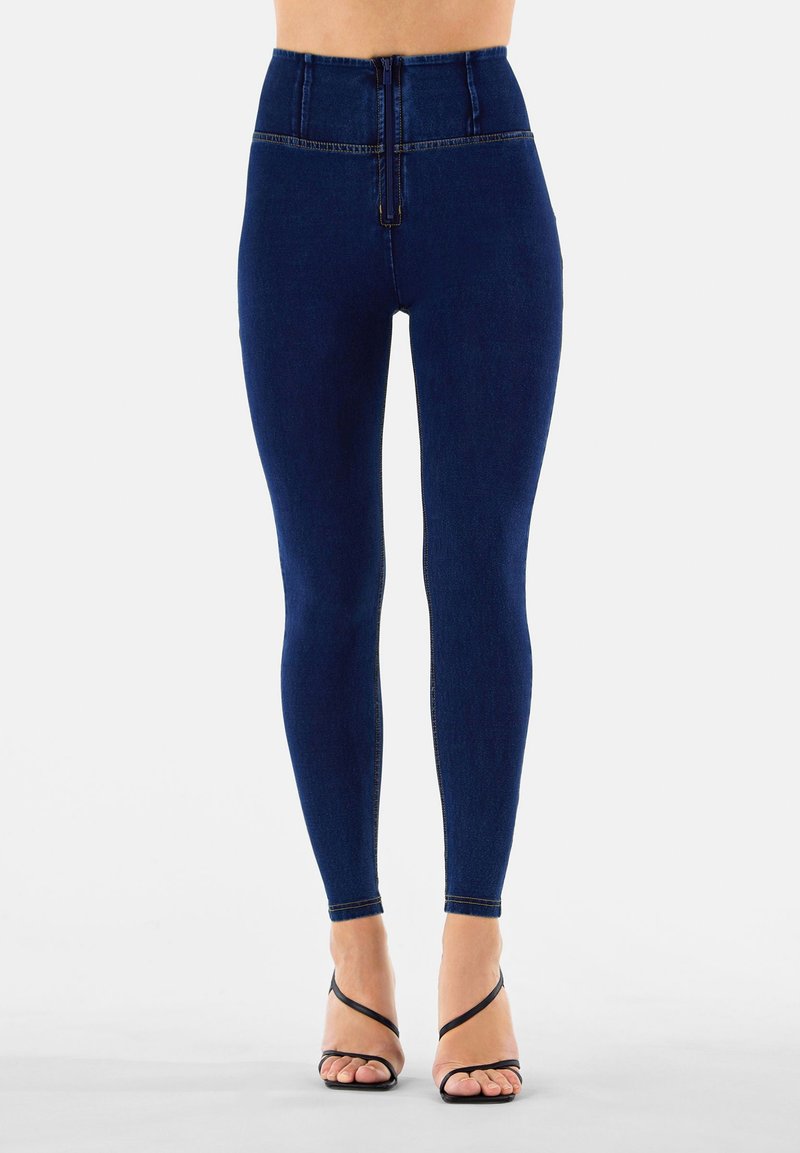 Laivastonsiniset korkeavyötäröiset leggingsit, joissa on sileä pinta, etuvetoketju, hienovaraiset saumat ja kapea istuvuus lahkeissa.