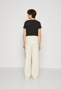Tommy Hilfiger TAPE RELAXED - Tracksuit bottoms - calico