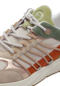 Sneaker with a mix of mesh and suede in beige, green, and orange. Features metallic accents, textured overlays, and patterned laces.