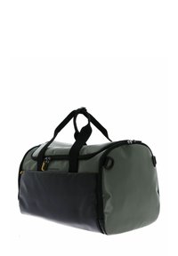 Sac de sport vert et noir en matériau durable et brillant. Caractérisé par des poignées doubles, une fermeture éclair et une forme ronde.