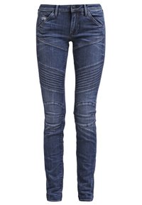 Jeans de mezclilla azul oscuro con un ajuste slim, paneles texturizados y acentos acanalados en las rodillas para un diseño estructurado.