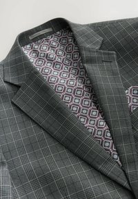 Gray plaid blazer with a structured collar, featuring a purple patterned lining. Material appears textured with a soft finish.