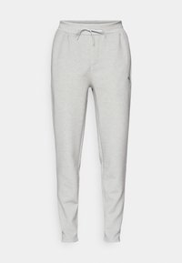 Lys grå joggers lavet af blødt stof, med elastisk talje med snor, sidelommer og hængende ben.