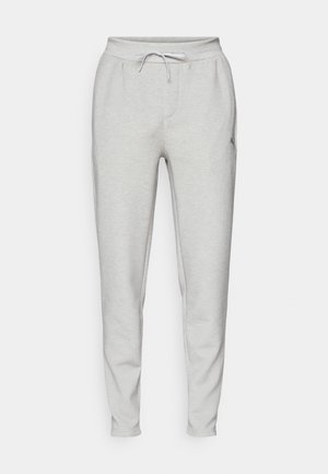 Lys grå joggers lavet af blødt stof, med elastisk talje med snor, sidelommer og hængende ben.