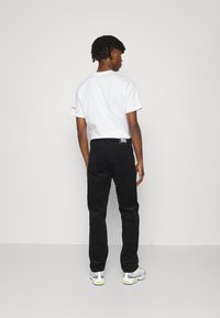 Dr.Denim DASH - Calças de ganga de perna direita - black cord