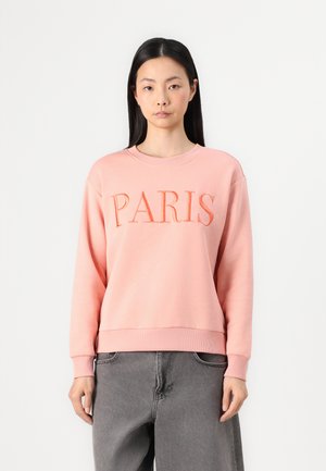 Roze sweatshirt met "PARIS" in geborduurde letters. Gemaakt van zacht materiaal met een ontspannen pasvorm en geribde manchetten en zoom.