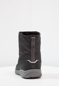 Schwarze isolierte Stiefel mit strukturiertem Stoff, grauer Gummisohle und Zuglasche. Verfügt über einen gepolsterten Kragen und eine Nahtdetail entlang der Nähte.