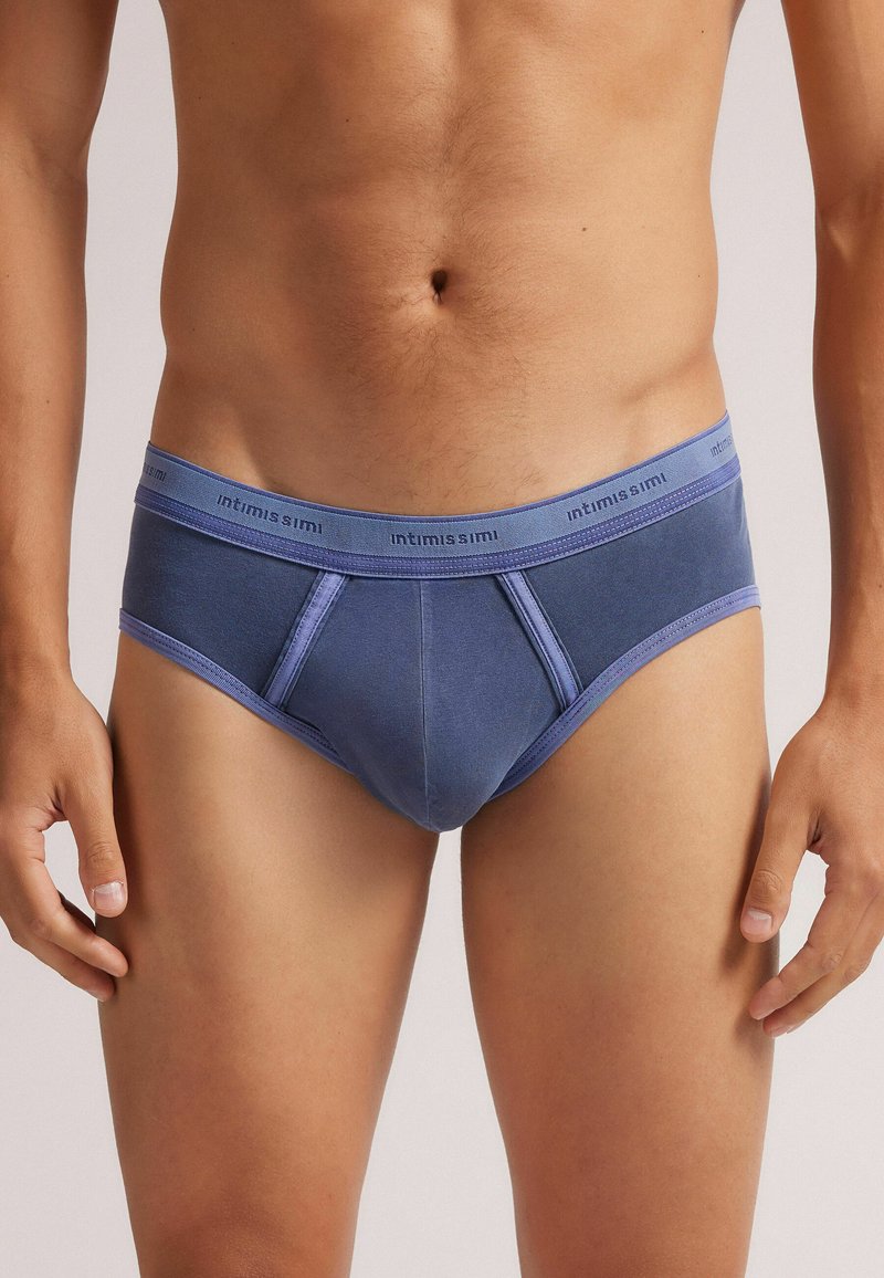 Męskie slipy w ciemnoniebieskim kolorze z bawełny, z jasnoniebieskim elastycznym pasem, z kontrastowymi szwami i dopasowanym krojem.