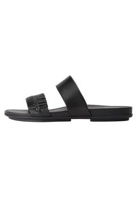 Svart lädersandal i slip-on-modell med en bred rem och vävda detaljer. Slät yta, platt sula och minimalistisk design.