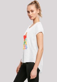 White short-sleeve t-shirt with a round neckline featuring a colorful graphic print of flowers and a heart design on the front.