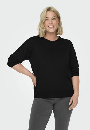 Maglione nero in maglia leggera con colletto rotondo e maniche a tre quarti, abbinato a pantaloni grigi. Design semplice e vestibilità comoda.