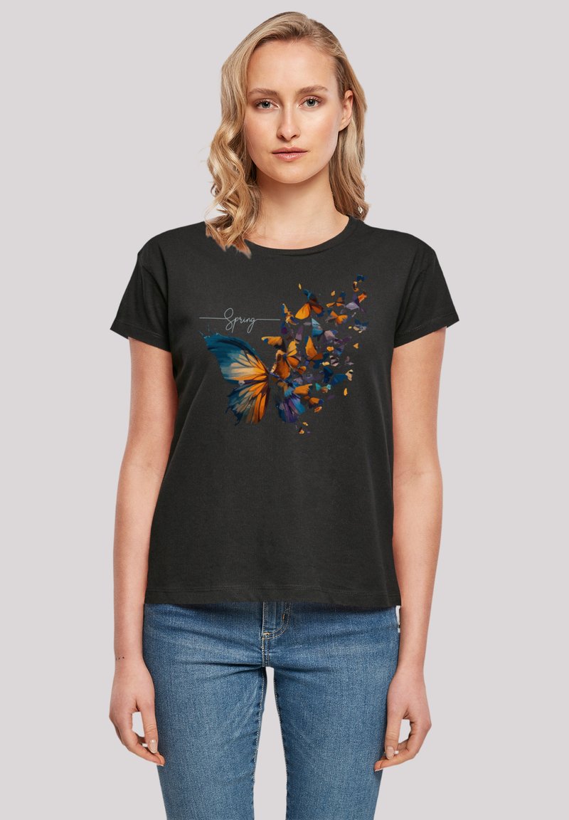Black t-shirt featuring a colorful butterfly graphic with orange, blue, and yellow accents. Short sleeves and a round neck design.