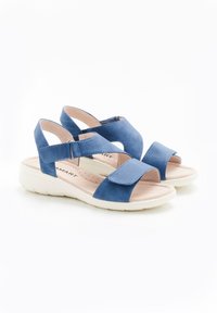 Sandalias azules con un empeine texturizado, correas ajustables y una plantilla acolchada. Presentan una suela blanca ligera y un diseño de punta abierta.